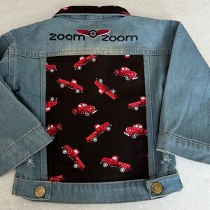 Denim child’s racing theme jacket. Size 9-12 M